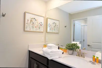 a bathroom with a sink and a mirror at Gorgeous 4 Bd w/ Pool at Champions Gate Resort 1020 in Orlando