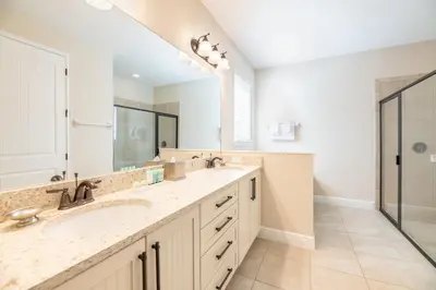 a bathroom with two sinks and a large mirror at Modern Home With Pool Table Near Disney With Waterpark & Resort Access At Encore Resort - 7644Ff in Kissimmee