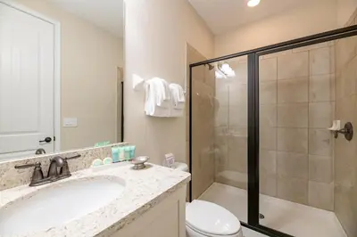 a bathroom with a sink and a shower and a toilet at Modern Home With Pool Table Near Disney With Waterpark & Resort Access At Encore Resort - 7644Ff in Kissimmee