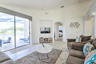 a living room with a couch and a table at 8 Mi to Disney World Home with Lanai and Game Room! in Kissimmee