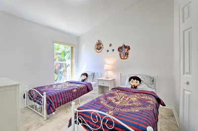 a bedroom with two beds and a window at 8 Mi to Disney World Home with Lanai and Game Room! in Kissimmee