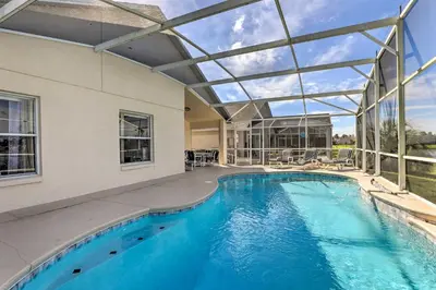 an indoor swimming pool with a glass ceiling at 8 Mi to Disney World Home with Lanai and Game Room! in Kissimmee