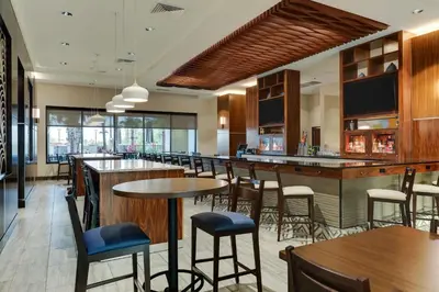 a restaurant with tables and chairs and a bar at Drury Plaza Hotel Orlando - Disney Springs Area in Orlando