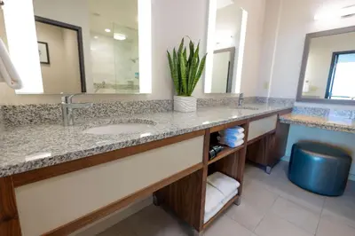 a bathroom with a sink and a large mirror at Drury Plaza Hotel Orlando - Disney Springs Area in Orlando