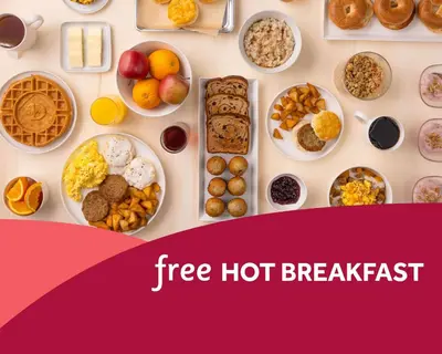 a table filled with different types of breakfast foods at Drury Plaza Hotel Orlando - Disney Springs Area in Orlando