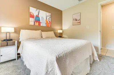 a bedroom with a white bed and a window at 7 Mi to Disney Family-Friendly Home with Pool! in Kissimmee
