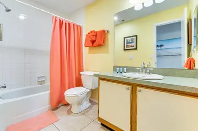 a bathroom with a sink and a toilet and a bath tub at 7 Mi to Disney Family-Friendly Home with Pool! in Kissimmee
