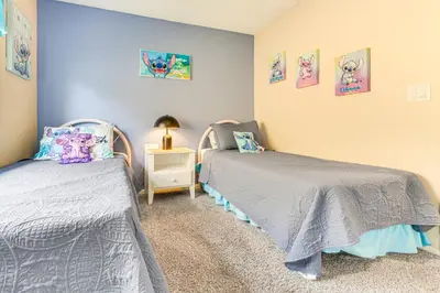 a bedroom with two twin beds and a night stand at 7 Mi to Disney Family-Friendly Home with Pool! in Kissimmee