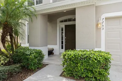 a front door of a house with a palm tree at WindsorHills Villa Pool Resort Amenities Minutes to Disney in Orlando