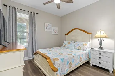a bedroom with a bed and a dresser and a window at WindsorHills Villa Pool Resort Amenities Minutes to Disney in Orlando