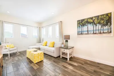 a living room with a couch and a table at Fabulous Cottage With Private Pool Near Disney With Margaritaville Resort & Island H2O Access - 8094Kd in Orlando