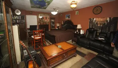 a living room with a bed and a couch and a table at Beautiful large bedroom in Orlando