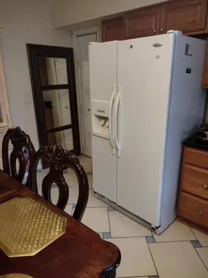 a white refrigerator in a kitchen with a table at Beautiful large bedroom in Orlando