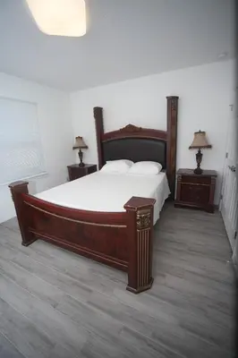 a bedroom with a large bed and two night stands at A beautiful queen bedroom in Orlando