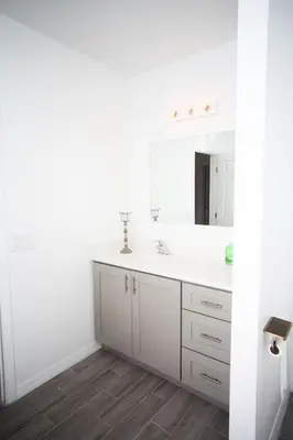 a white bathroom with a sink and a mirror at A beautiful queen bedroom in Orlando