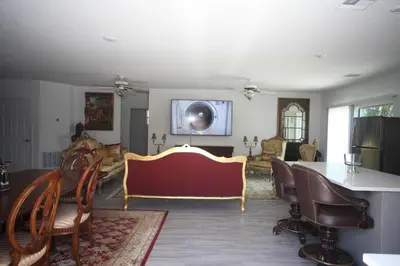 a living room with a table and chairs at A beautiful queen bedroom in Orlando