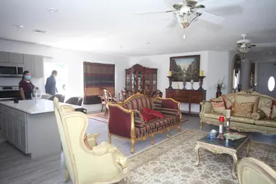 a living room with furniture and people in it at A beautiful queen bedroom in Orlando