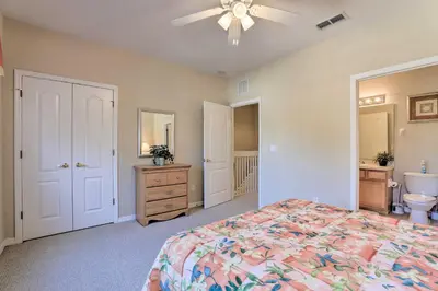 a bedroom with a bed and a sink and a toilet at 6 Mi to WDW Family-Friendly Townhome with Foosball! in Kissimmee