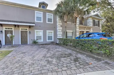 a house with a car parked in front of it at 6 Mi to WDW Family-Friendly Townhome with Foosball! in Kissimmee