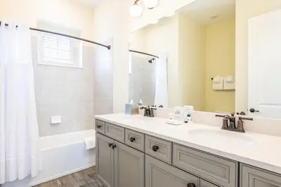 a bathroom with two sinks and a shower and a tub at Comfy Cottage Near Disney With Margaritaville Resort & Island H20 Waterpark Access - 2926Sr in Orlando