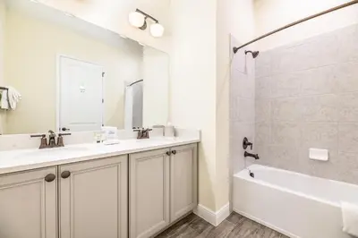 a bathroom with two sinks and a tub and a shower at Comfy Cottage Near Disney With Margaritaville Resort & Island H20 Waterpark Access - 2926Sr in Orlando