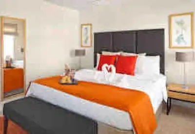 a bedroom with a large bed with red pillows at Regal Oaks Resort Townhouse in Kissimmee