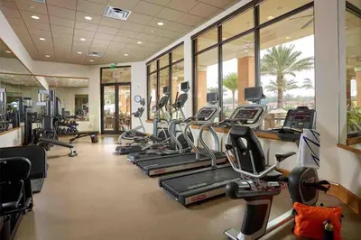 a gym with several treadmills and elliptical machines at Regal Oaks Resort Townhouse in Kissimmee