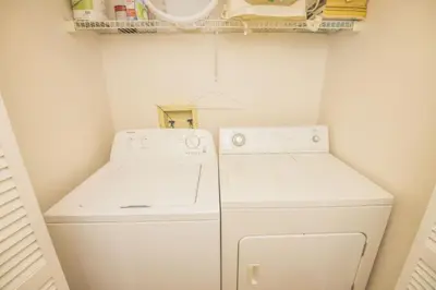a small laundry room with a washer and dryer at 3 Bedroom Resort Condo 8 Miles to Disney Pool Free Parking in Kissimmee