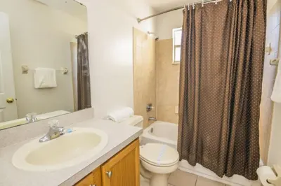 a bathroom with a sink and a toilet and a shower at 3 Bedroom Resort Condo 8 Miles to Disney Pool Free Parking in Kissimmee