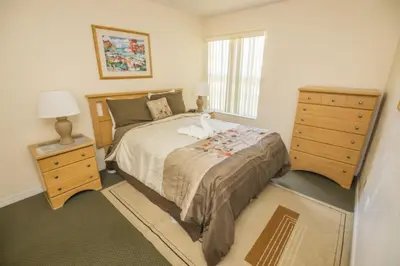 a bedroom with a bed and a dresser and a window at 3 Bedroom Resort Condo 8 Miles to Disney Pool Free Parking in Kissimmee