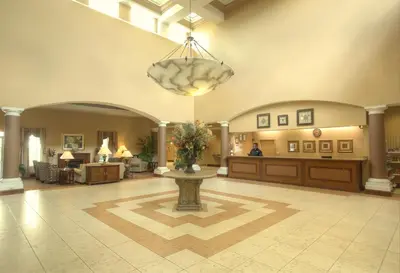 a lobby with a large lobby with a vase of flowers at Hawthorn Extended Stay by Wyndham Orlando in Orlando