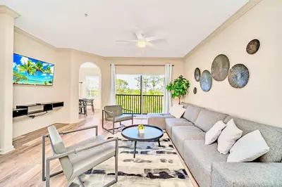a living room with a couch and a table at Spacious 3BR Condo with Pool, near Disney! in Orlando