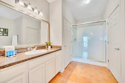 a bathroom with a sink and a shower at Spacious 2BR Condo with Pool , near Disney! in Orlando