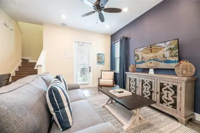 a living room with a couch and a ceiling fan at Dreamy Cottage Near Disney With Margaritaville Resort & Island H20 Waterpark Access - 2944Sr in Orlando