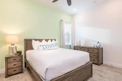 a bedroom with a large bed and two night stands at Dreamy Cottage Near Disney With Margaritaville Resort & Island H20 Waterpark Access - 2950Sr in Orlando
