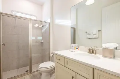 a bathroom with a toilet and a sink and a shower at Dreamy Cottage Near Disney With Margaritaville Resort & Island H20 Waterpark Access - 2950Sr in Orlando