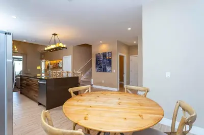 a dining room with a wooden table and a kitchen at Beautiful Magic Village 4 Suites near Disney 7493 in Orlando