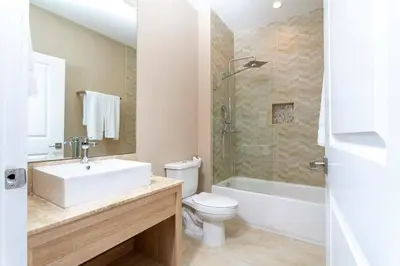 a bathroom with a sink and a toilet and a shower at Beautiful Magic Village 4 Suites near Disney 7493 in Orlando