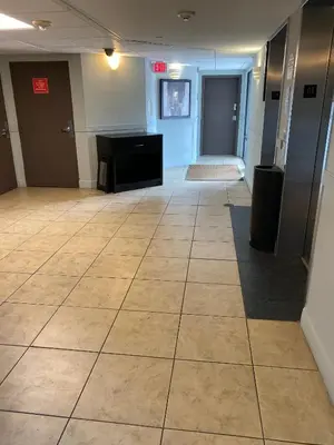 an empty room with a tile floor in a building at Spacious Studio close to Theme Parks in Orlando