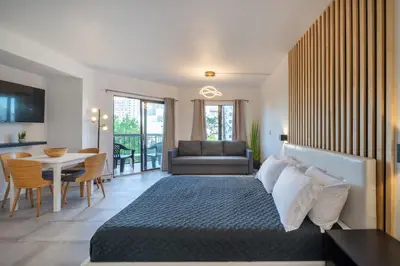 a hotel room with a bed and a dining room at Spacious Studio close to Theme Parks in Orlando