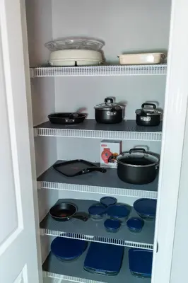 a pantry with pots and pans on shelves at Pet Friendly Modern Zen Studio Retreat with Hot Tub! home in Orlando