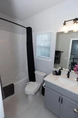 a bathroom with a toilet and a tub and a sink at Pet Friendly Modern Zen Studio Retreat with Hot Tub! home in Orlando