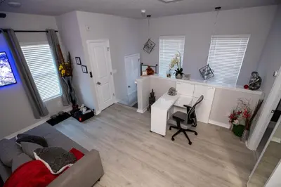 a living room with a couch and a desk at Pet Friendly Modern Zen Studio Retreat with Hot Tub! home in Orlando