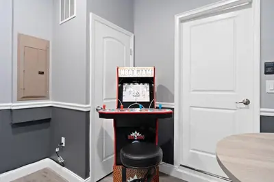 a room with a table with a video game at Storey Lake -6 Bedrooms Luxury home w-pool & spa in Kissimmee