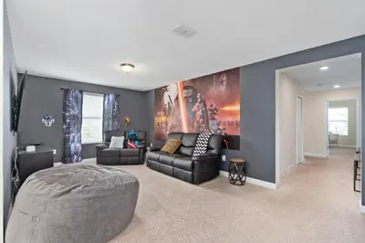 a living room with a bed and a couch at Storey Lake -6 Bedrooms Luxury home w-pool & spa in Kissimmee