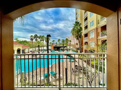 a view of the pool from a balcony at a resort at Premier Resort Condos Near Disney & Universal in Orlando