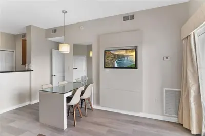 a dining room with a glass table and chairs at Premier Resort Condos Near Disney & Universal in Orlando