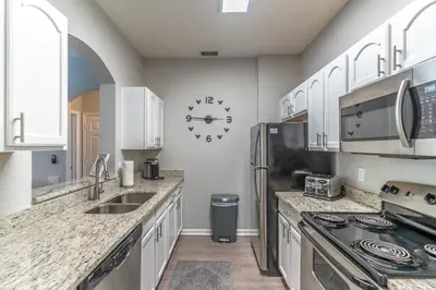 a kitchen with white cabinets and a stainless steel refrigerator at 2821 Windsor Hills in Orlando