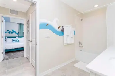 a bathroom with a shower and a bedroom at Family Friendly 2 Bd Close to Disney @ Storey Lake 105 3161 in Kissimmee