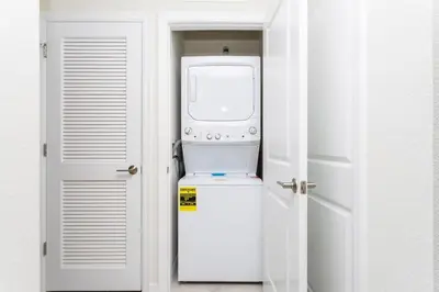 a white refrigerator with a microwave on top of it at Family Friendly 2 Bd Close to Disney @ Storey Lake 105 3161 in Kissimmee